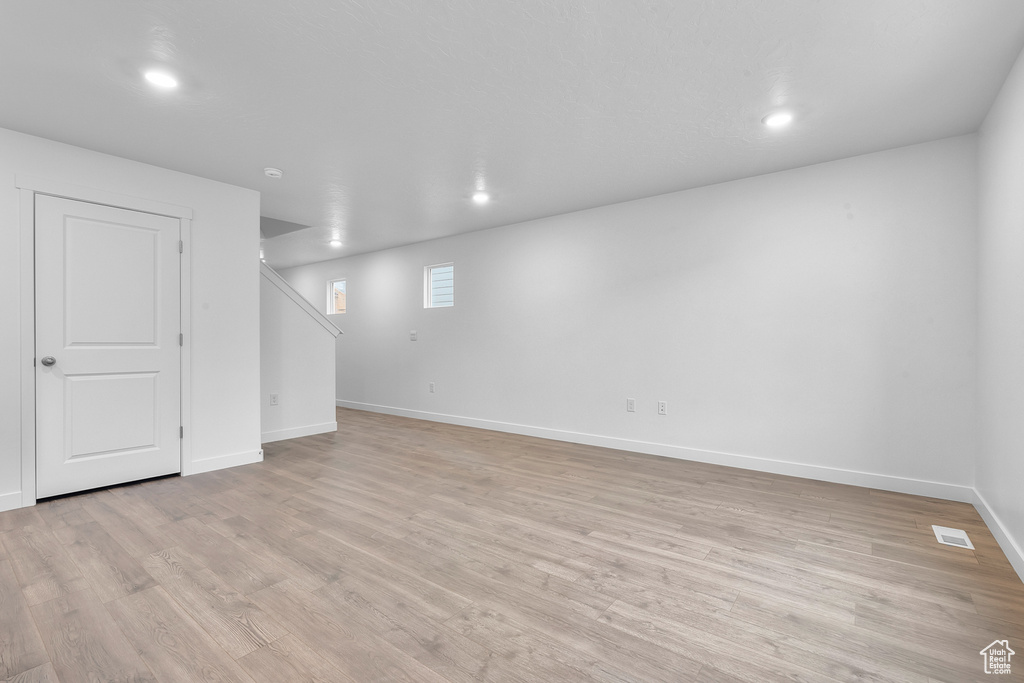 Basement featuring recessed lighting, baseboards, visible vents, and light wood finished floors
