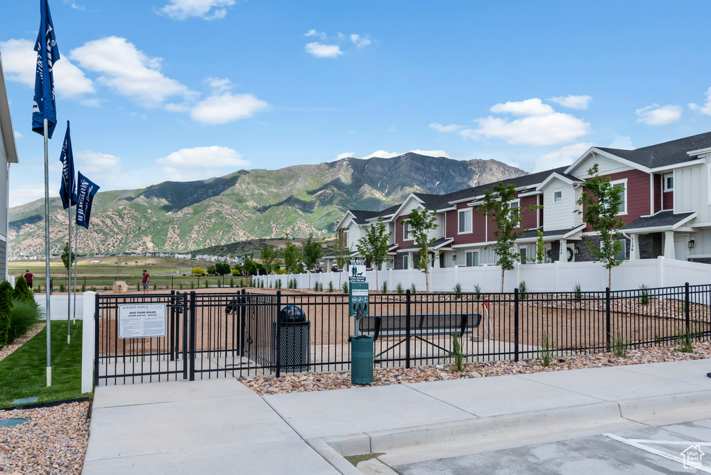 View of front of property with a residential view, fence, and a mountain view