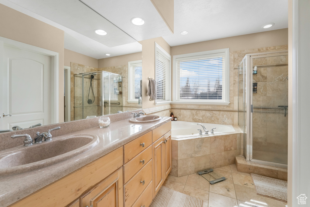 Full bathroom with tile patterned flooring, a sink, a bath, and a shower stall