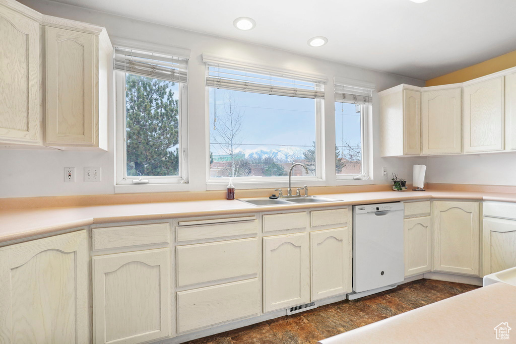 Kitchen featuring recessed lighting, light countertops, visible vents, a sink, and dishwasher