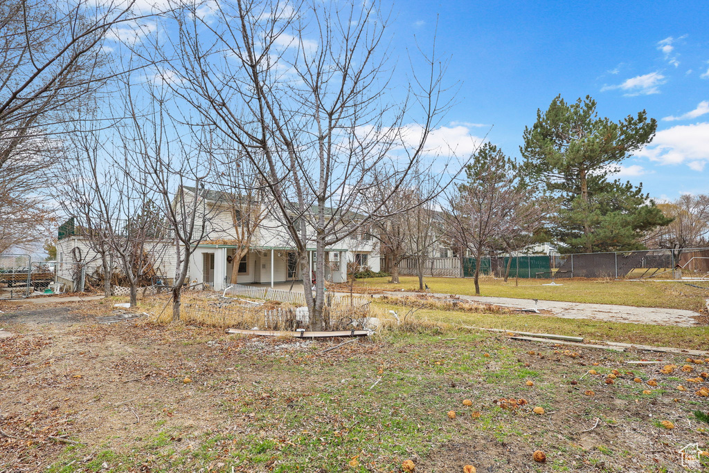 View of yard with fence and a patio