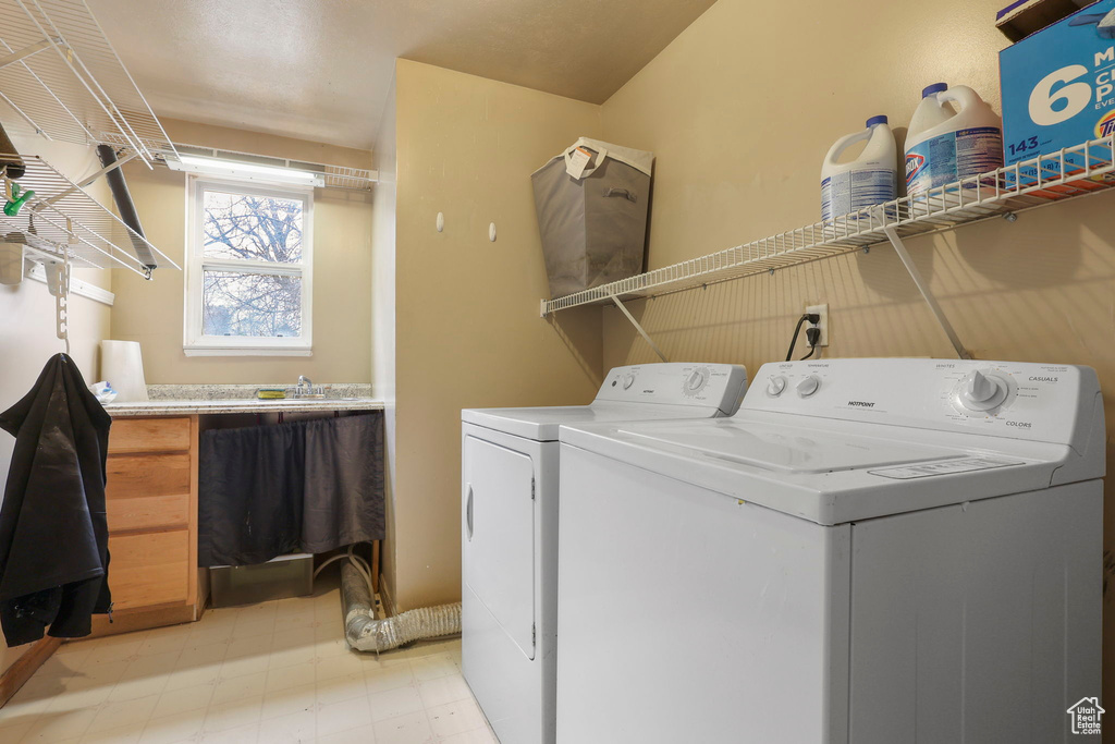 Laundry room featuring laundry area, separate washer and dryer, and light floors