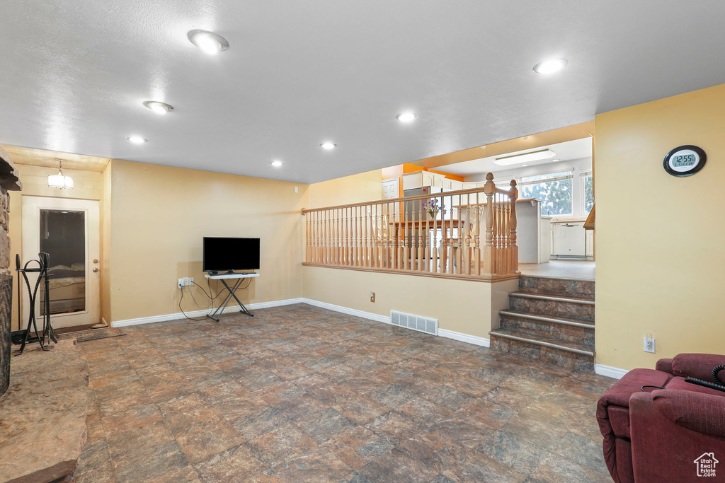 Living area with stairs, recessed lighting, visible vents, and baseboards