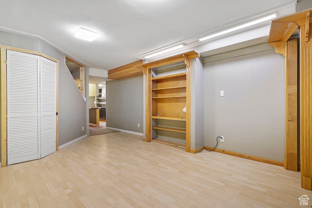 Finished basement featuring light wood-style flooring and baseboards