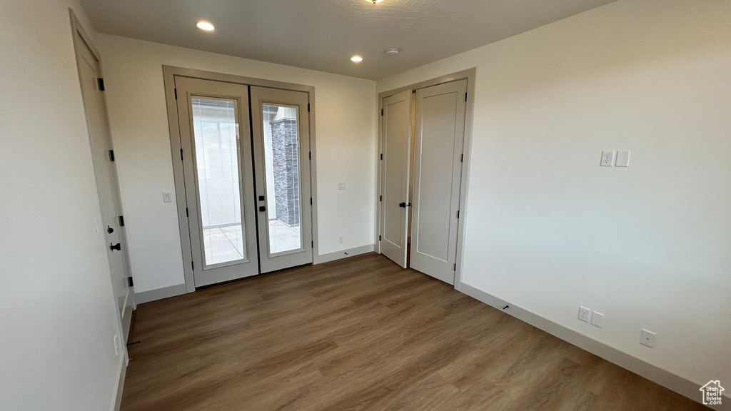 Entryway featuring french doors, baseboards, plenty of natural light, and wood finished floors