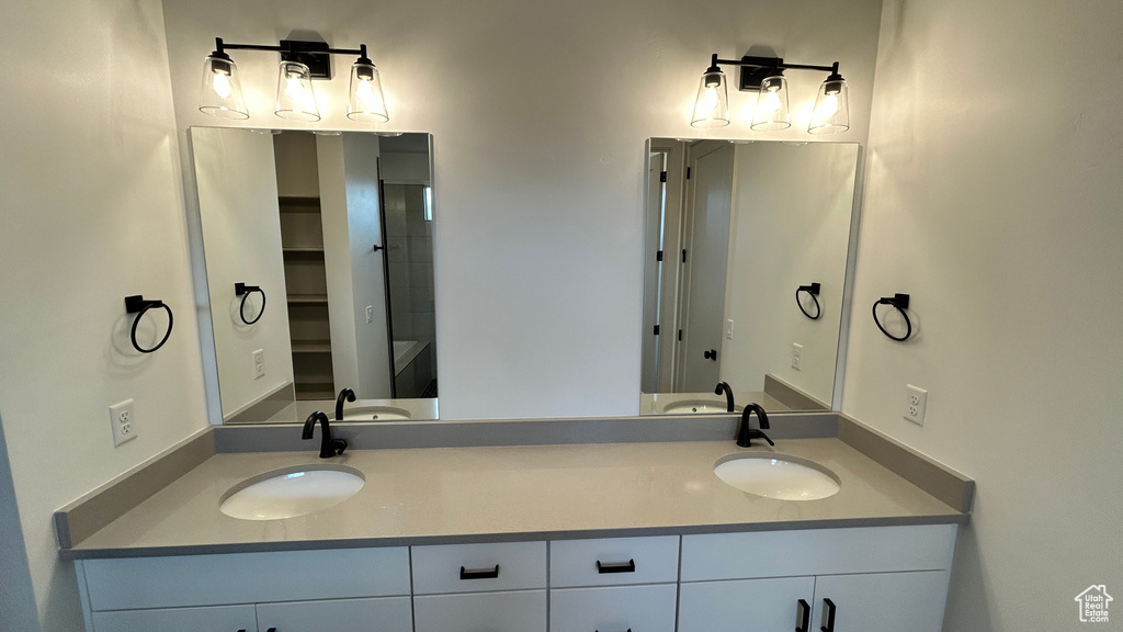 Bathroom featuring double vanity and a sink