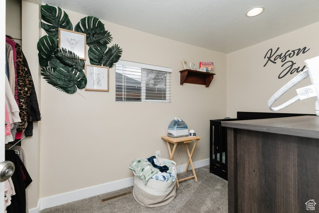 Carpeted bedroom with visible vents and baseboards