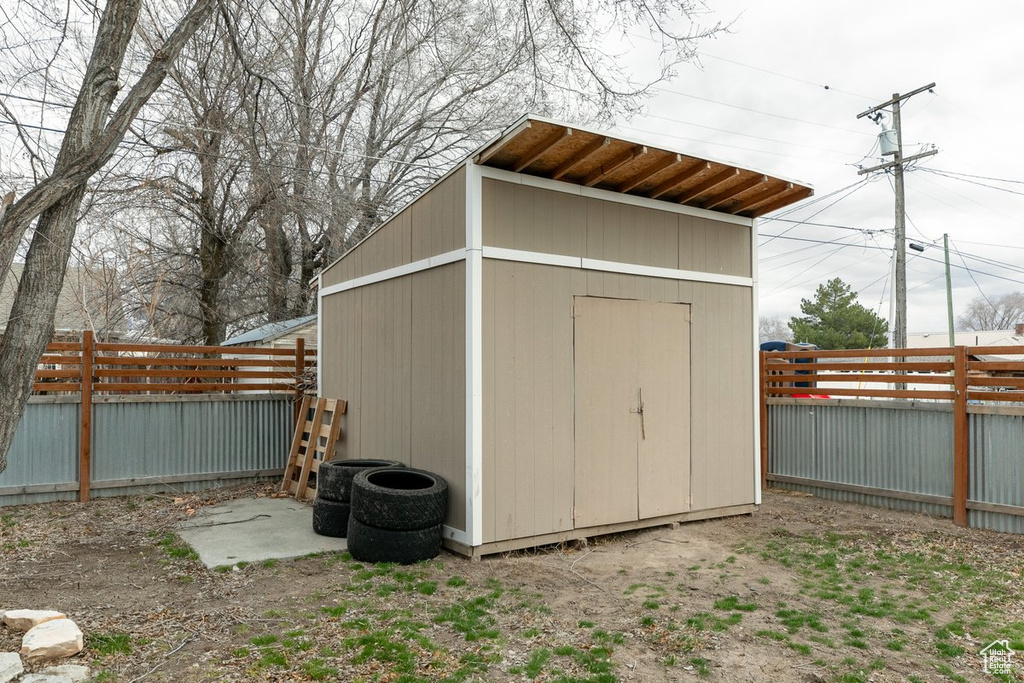 View of shed with a fenced backyard