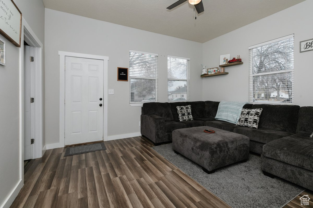 Living area featuring ceiling fan, wood finished floors, and baseboards