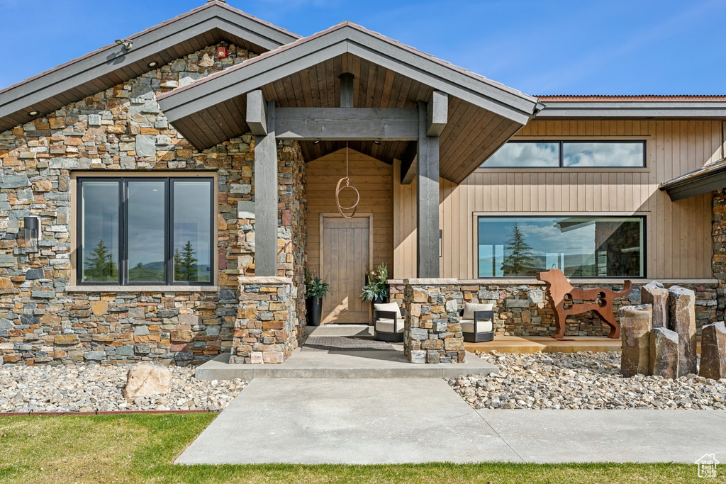 Property entrance featuring stone siding