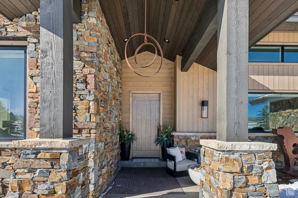Doorway to property featuring stone siding