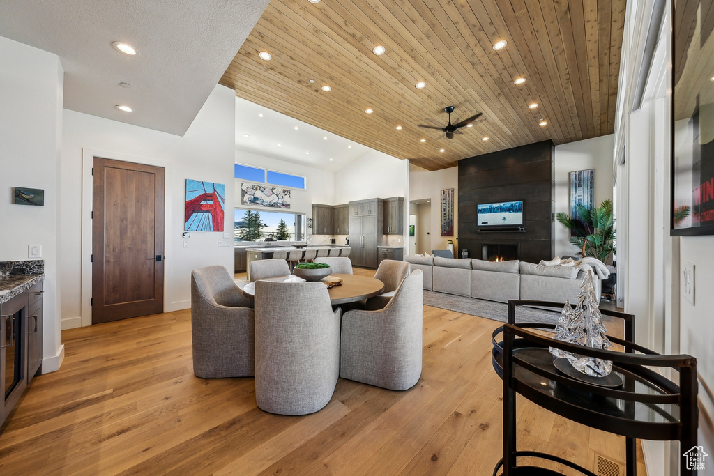 Dining room featuring light wood-type flooring, recessed lighting, wooden ceiling, vaulted ceiling, and a ceiling fan