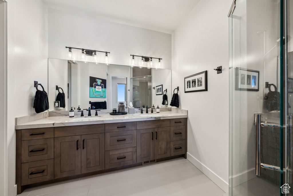 Bathroom with double vanity and a stall shower