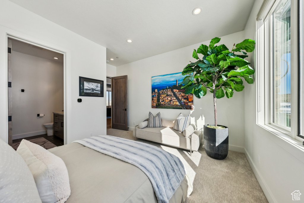 Bedroom with multiple windows, recessed lighting, ensuite bath, and carpet floors