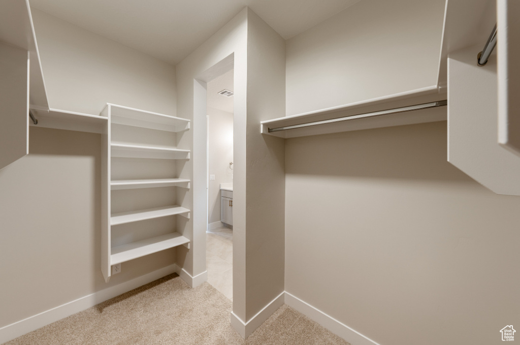 Walk in closet featuring carpet floors and visible vents