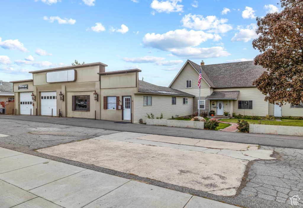 View of front of home featuring a garage and aphalt driveway