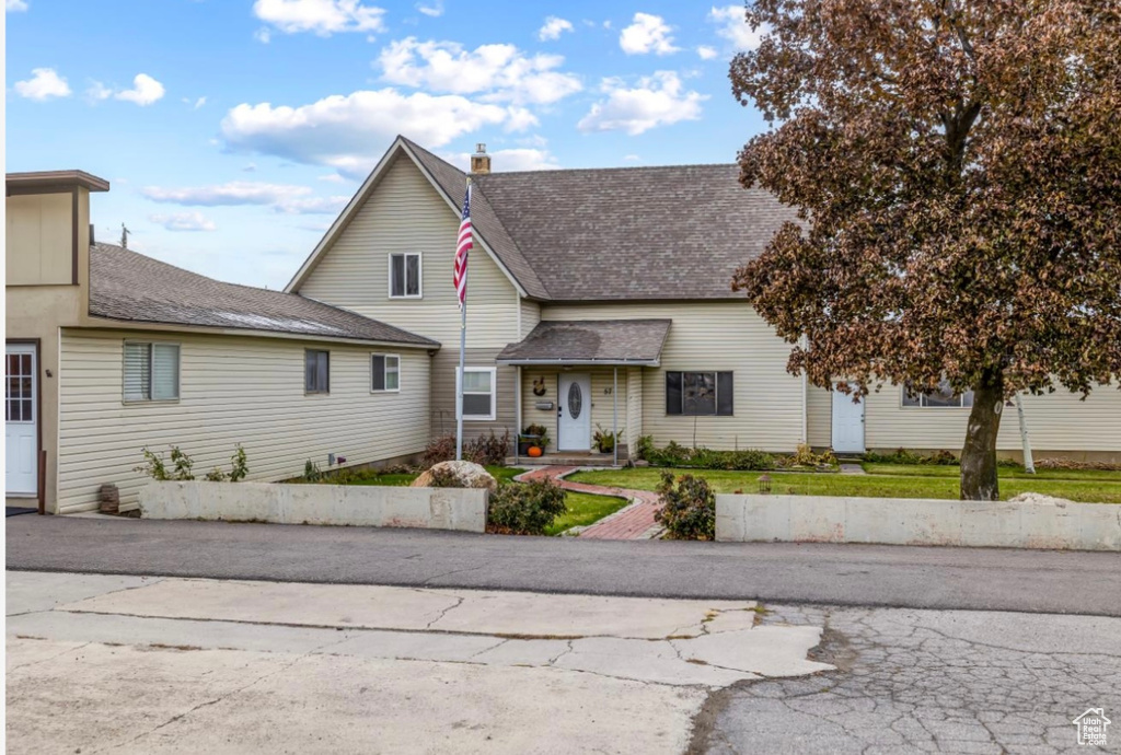 Traditional home with a shingled roof and a chimney