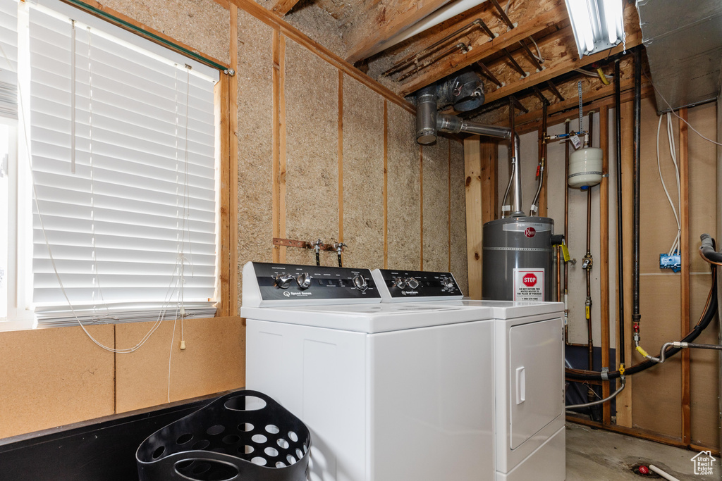 Clothes washing area with strapped water heater, independent washer and dryer, and laundry area