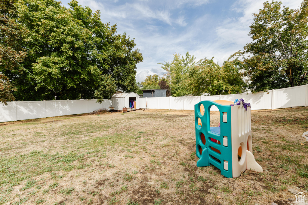 View of yard featuring an outbuilding, a shed, and a fenced backyard