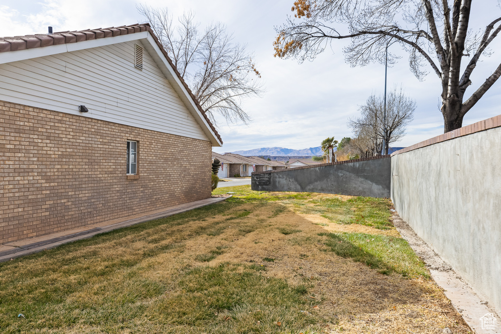 View of yard featuring fence