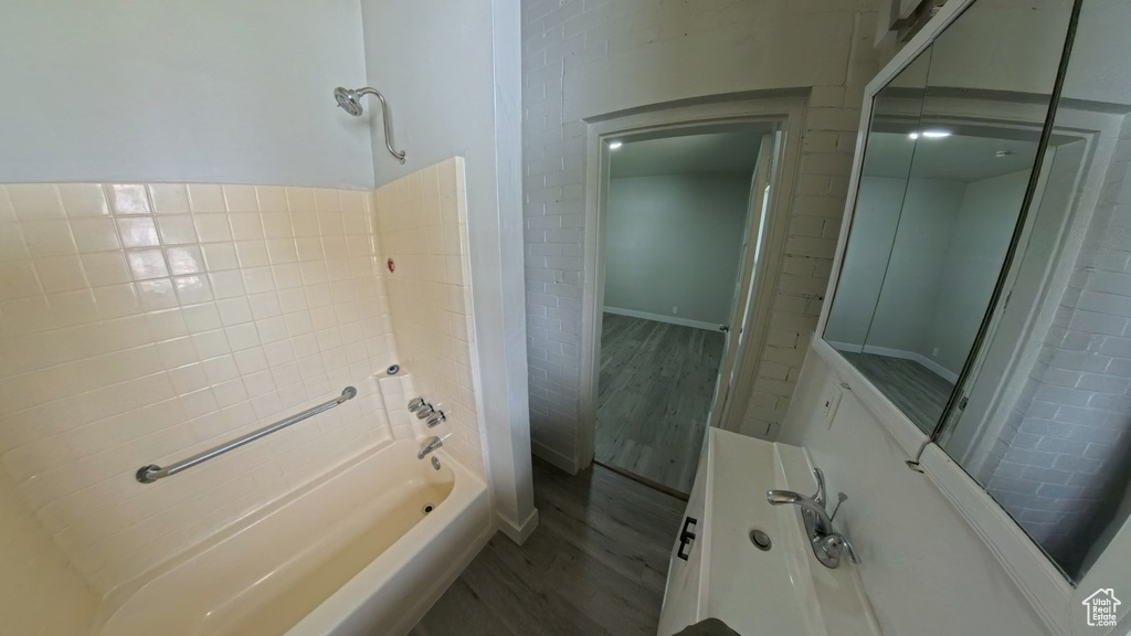 Bathroom featuring shower / washtub combination and wood finished floors