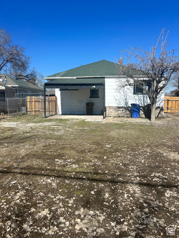 Back of house with fence and a chimney