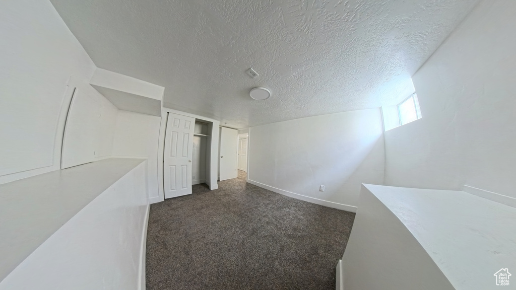 Interior space featuring baseboards and a textured ceiling