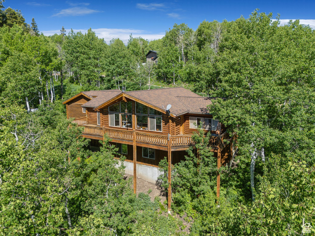 Rear view of property with log exterior and a wooden deck
