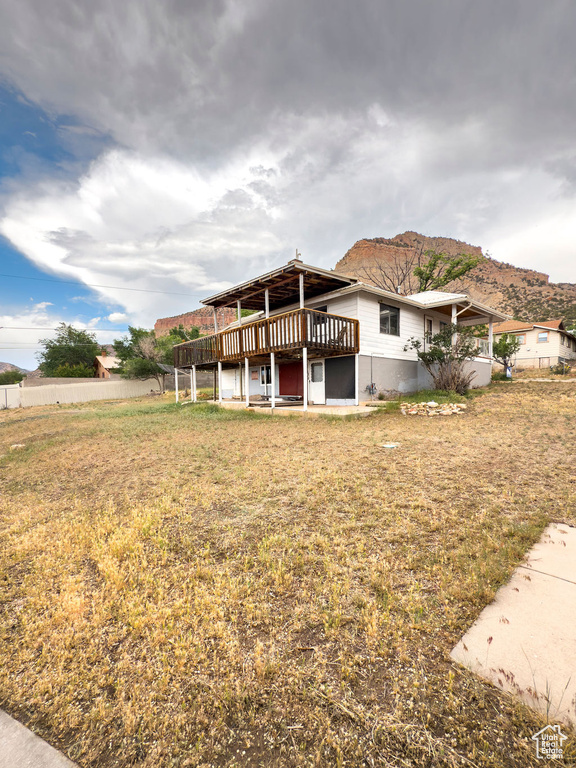 Back of house featuring a wooden deck