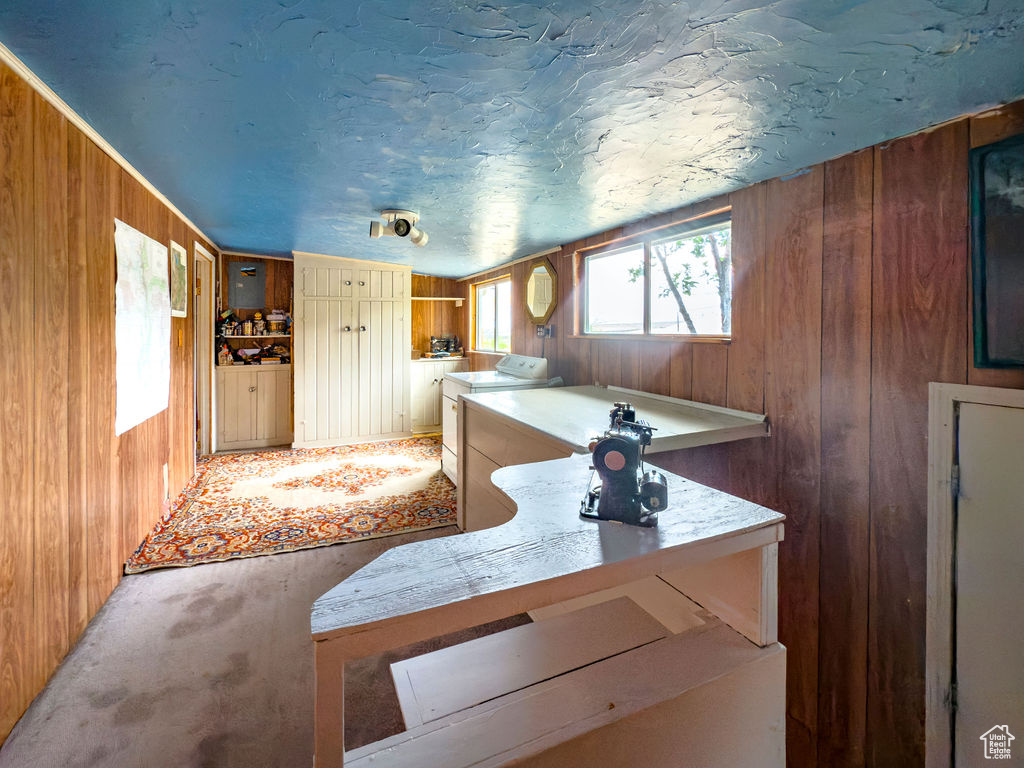 Kitchen with wood walls and light countertops