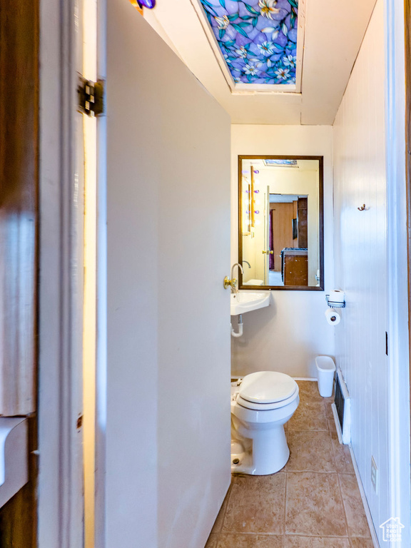 Bathroom with toilet and tile patterned flooring