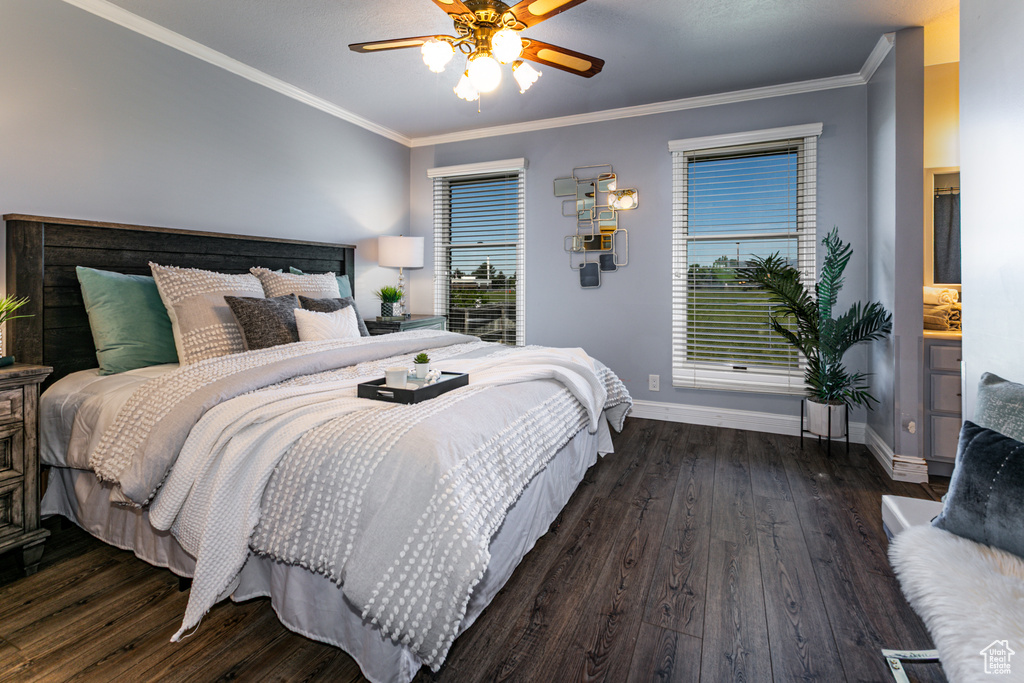 Bedroom with wood finished floors, baseboards, ornamental molding, and ceiling fan
