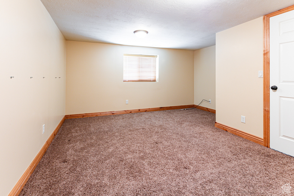 Spare room with carpet and baseboards