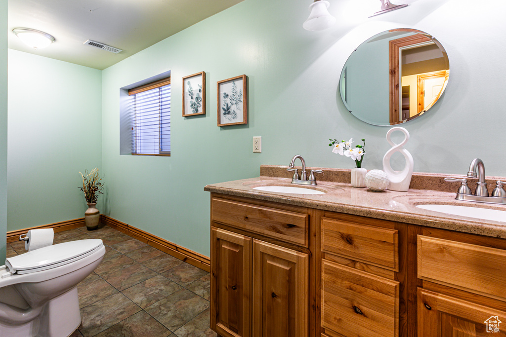 Full bathroom featuring visible vents, a sink, and double vanity