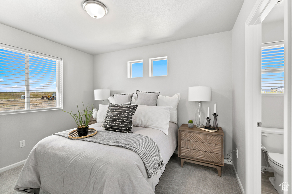 Carpeted bedroom featuring baseboards