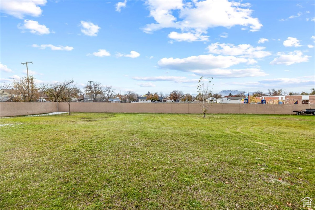 View of yard featuring fence