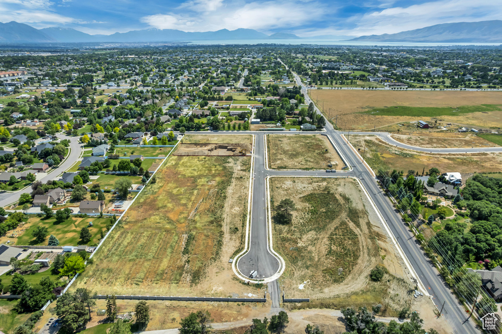 Aerial view of property's location featuring a mountain backdrop