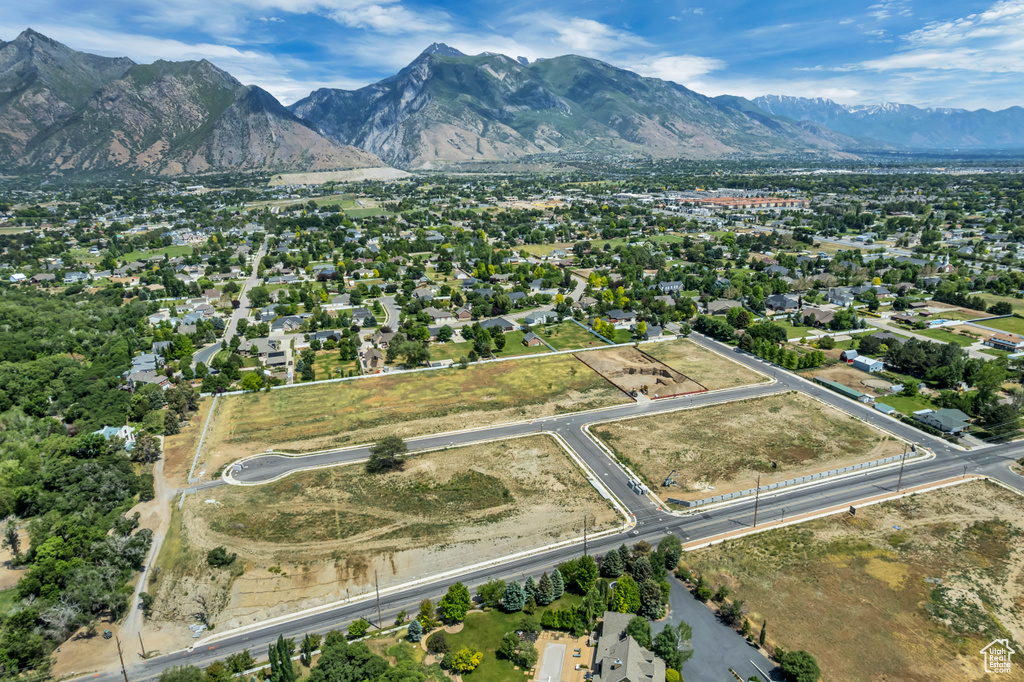Aerial view of property's location with a mountainous background and property parcel outlined