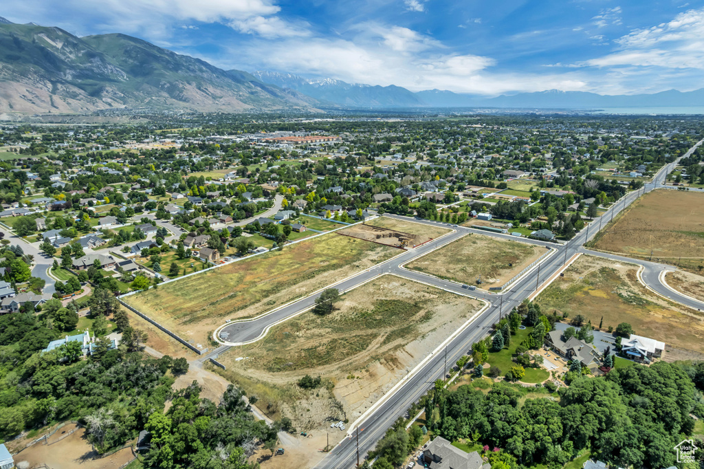 Aerial view of property and surrounding area featuring mountains