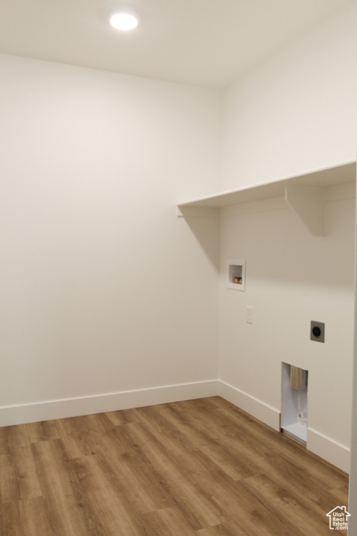 Washroom with hookup for a washing machine, light wood-style flooring, electric dryer hookup, baseboards, and recessed lighting