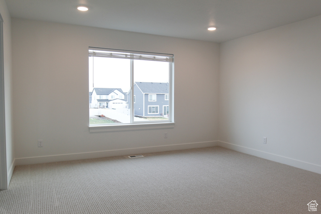 Empty room with baseboards, carpet flooring, and recessed lighting