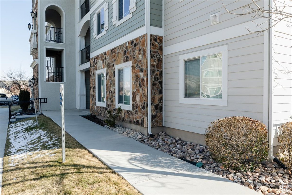 Entrance to property featuring stone siding