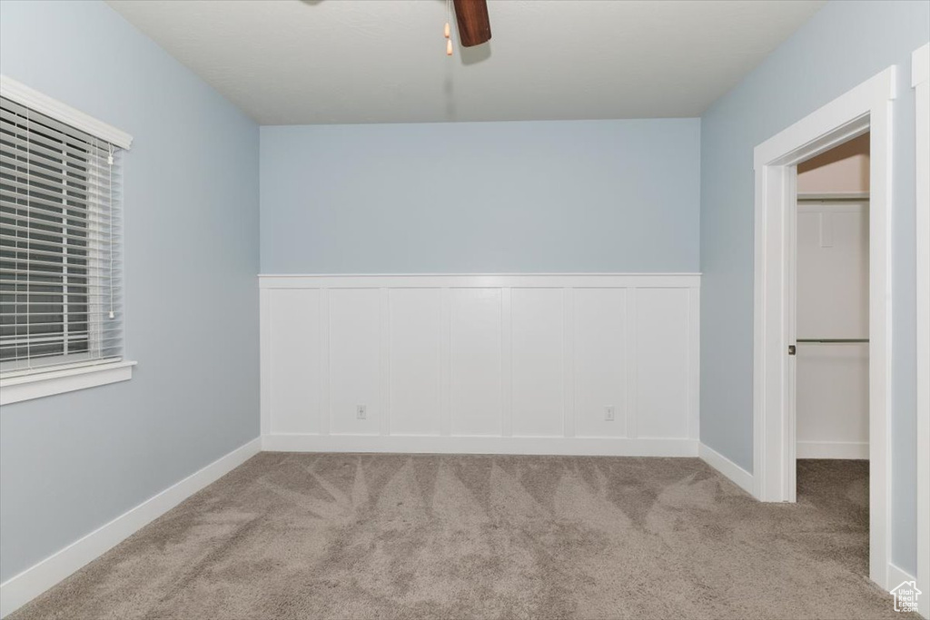 Spare room featuring carpet floors and ceiling fan