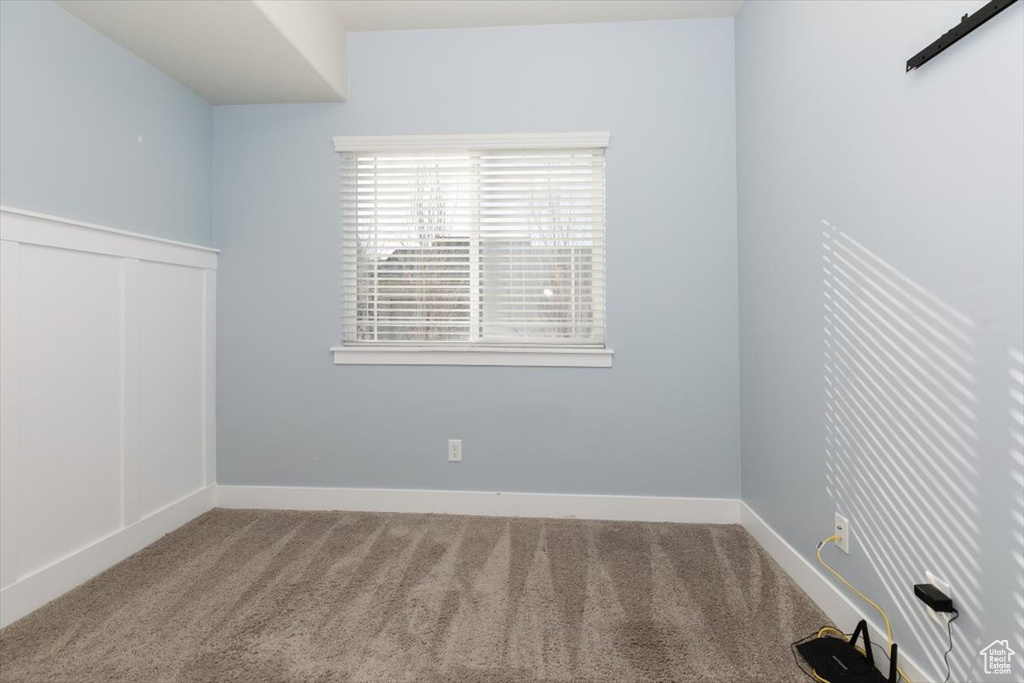 Empty room with carpet flooring and baseboards