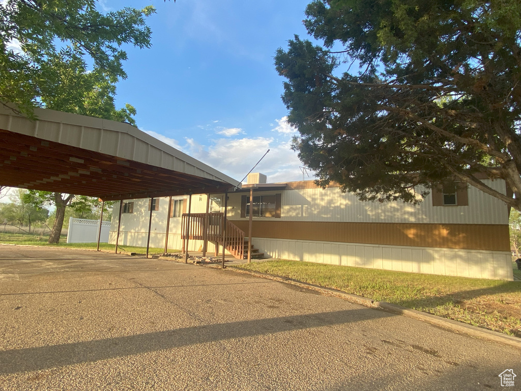 Exterior space featuring a carport and driveway