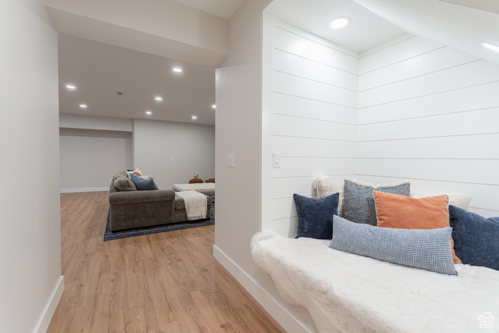 Bedroom with baseboards, wood finished floors, and recessed lighting