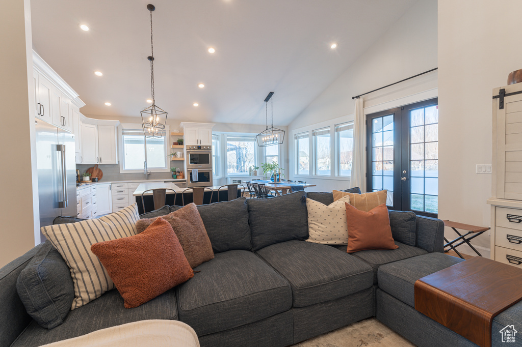 Living room featuring vaulted ceiling, french doors, and recessed lighting