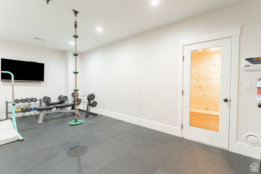 Exercise area with recessed lighting, visible vents, and baseboards