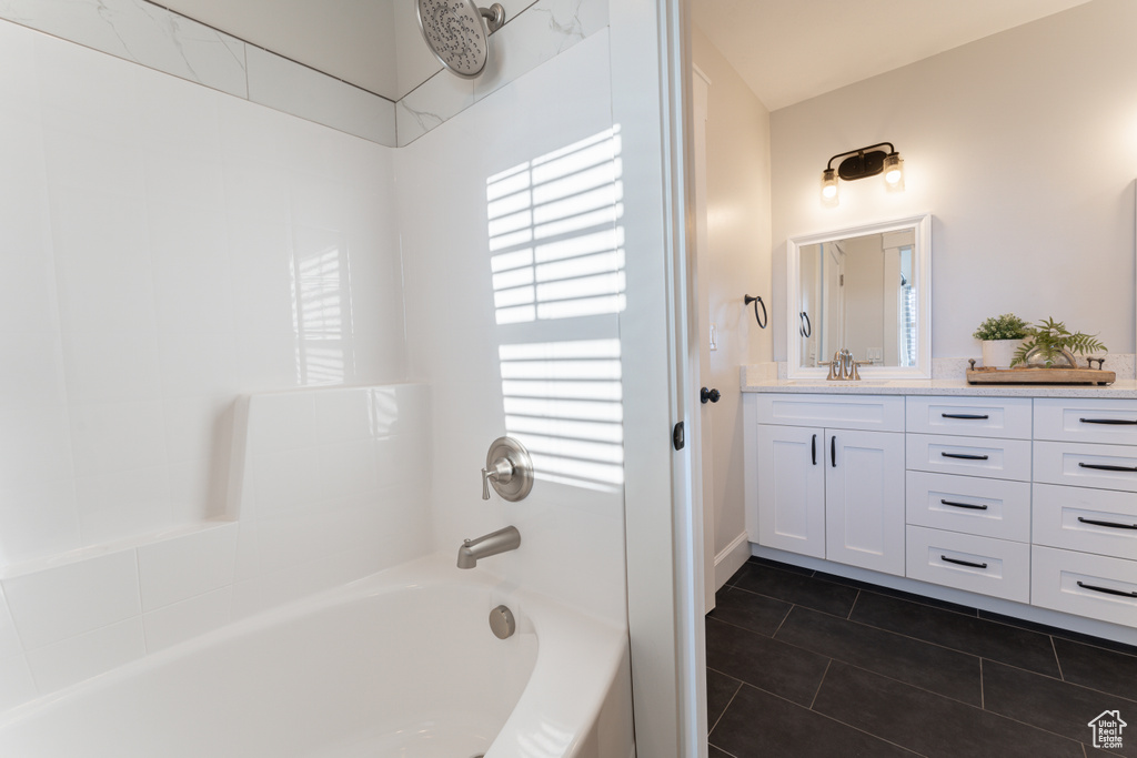 Full bath featuring tub / shower combination, vanity, and tile patterned floors