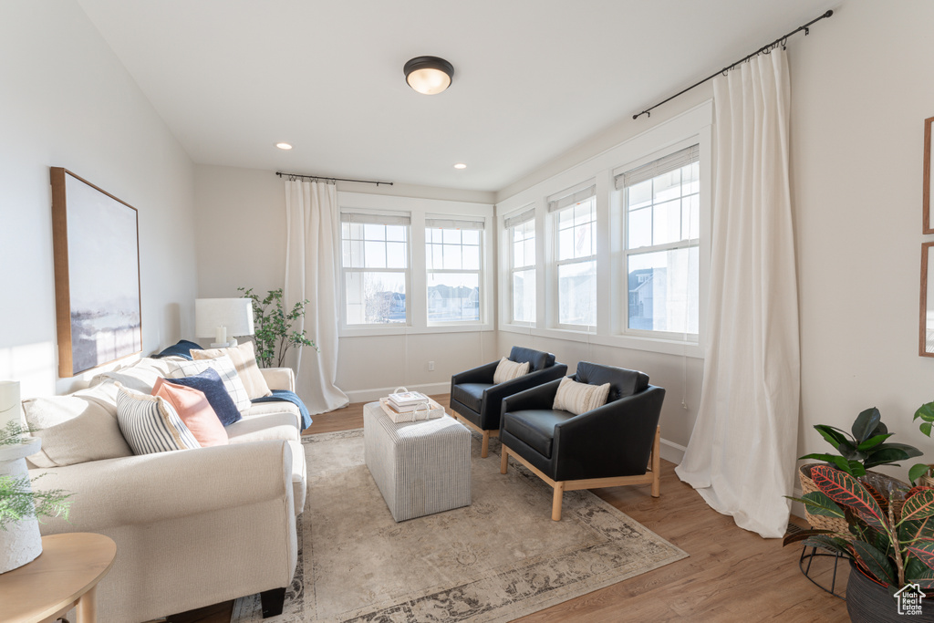 Living area featuring recessed lighting, wood finished floors, and baseboards